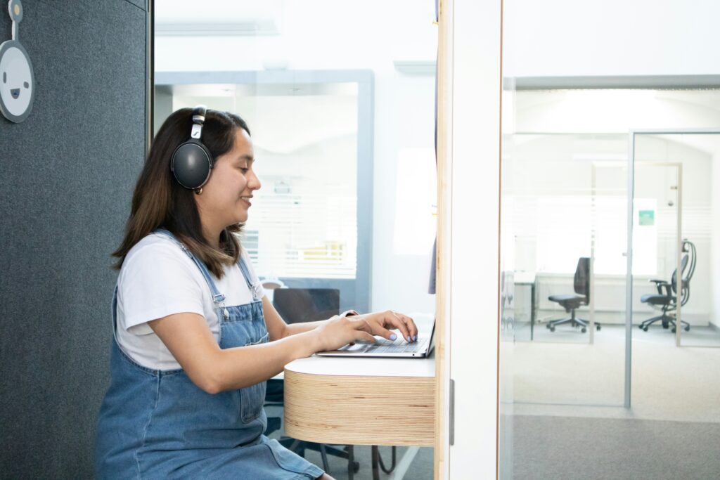 Person sitting in an office with headphones on