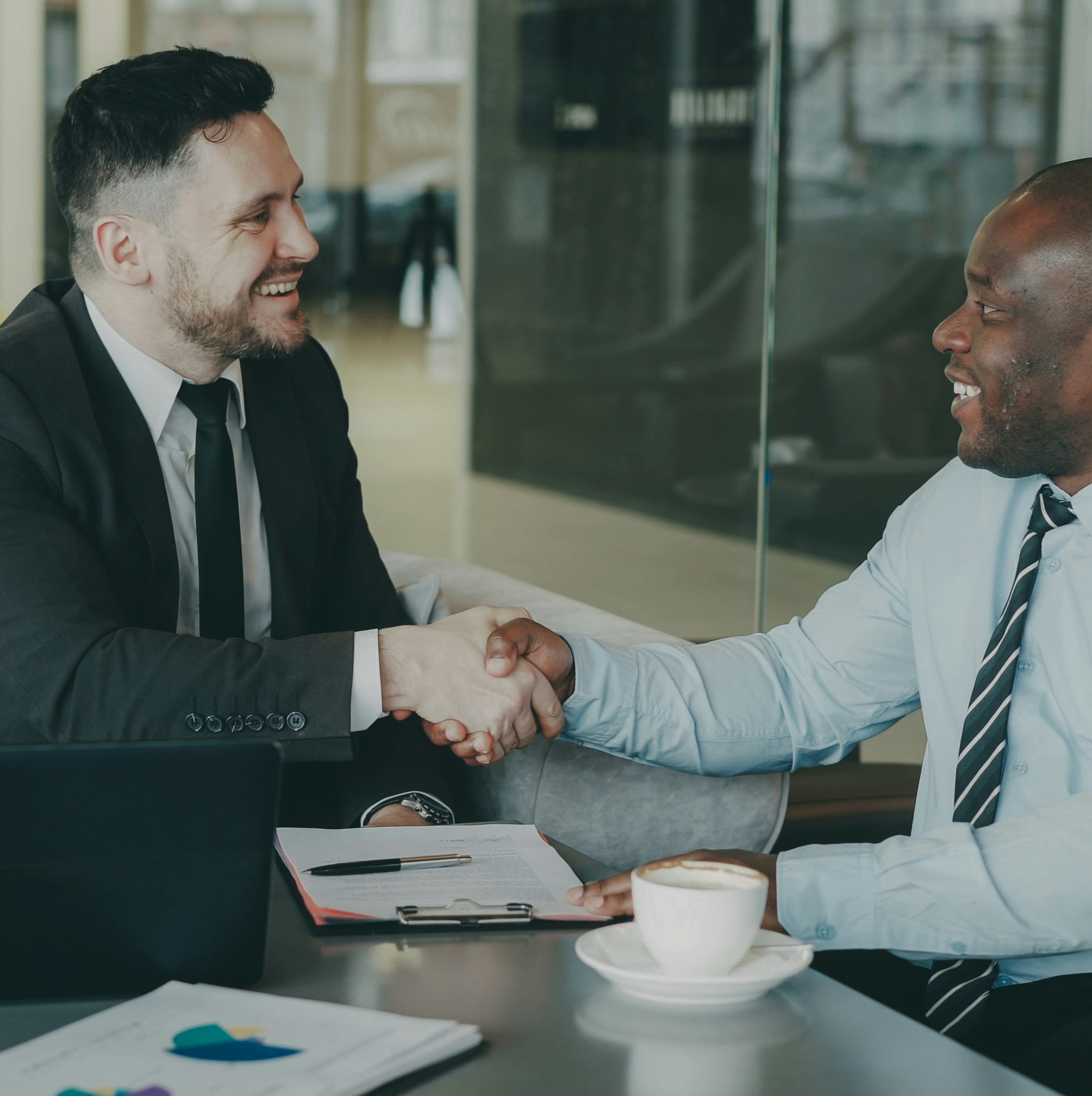 Two people sitting and shaking hands